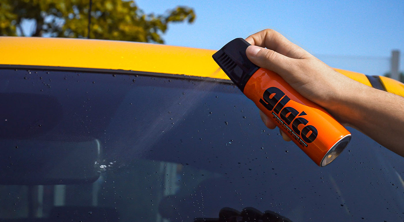 Soft99 car care product Glaco W-Jet being sprayed on a car's windscreen.